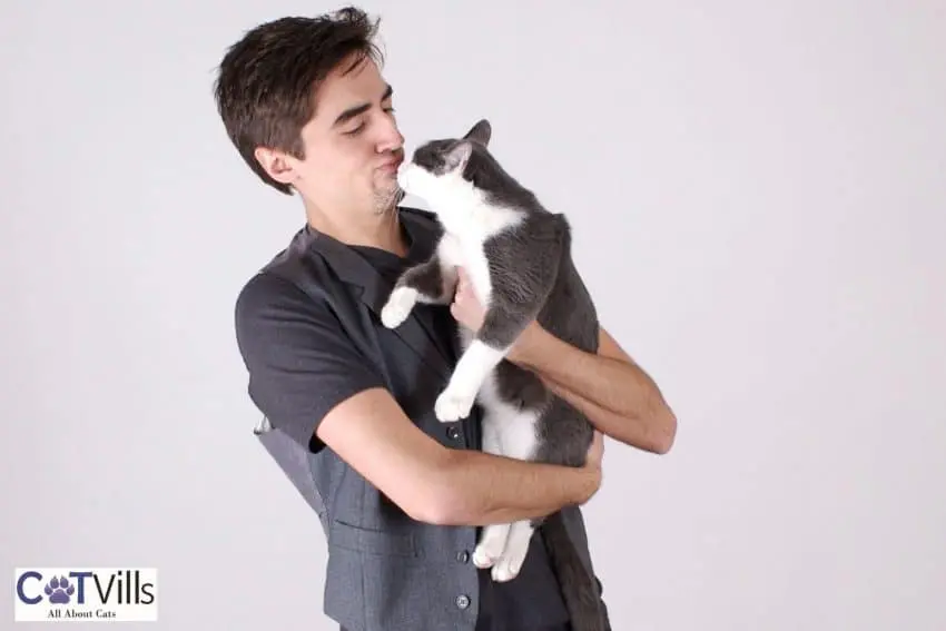 man kissing her cat