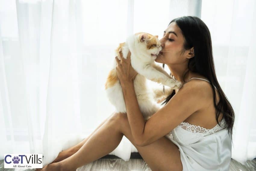 woman kissing her cat